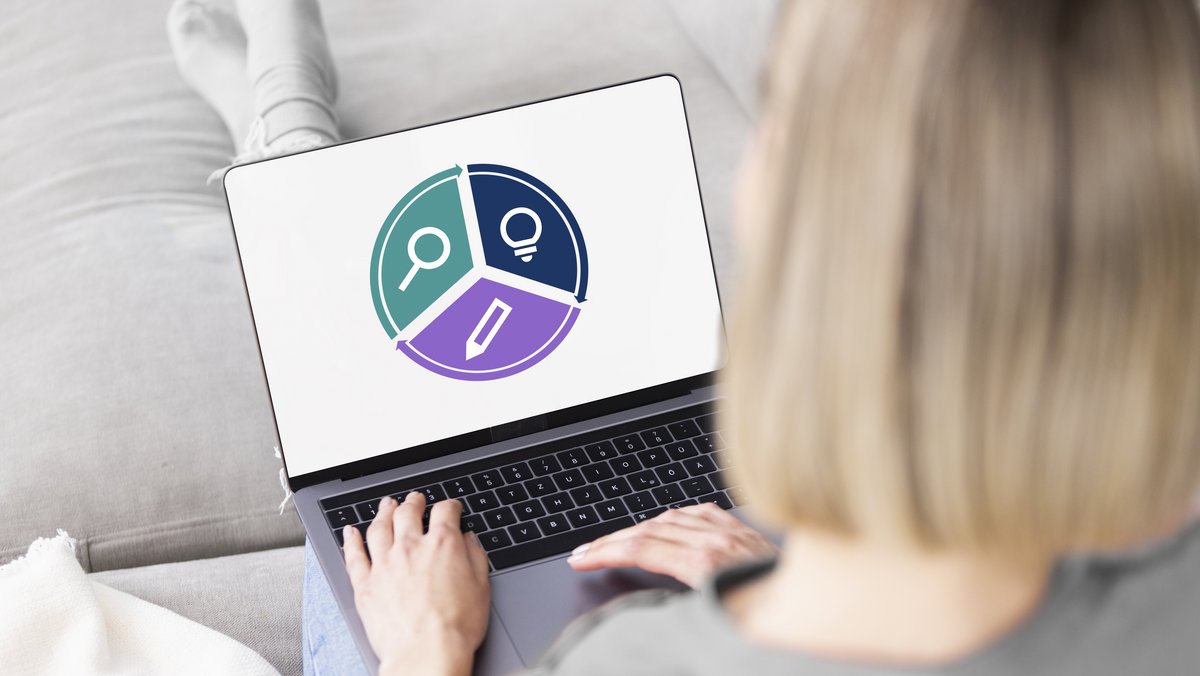 Жінка працює за ноутбуком із фінансовою діаграмою на екрані